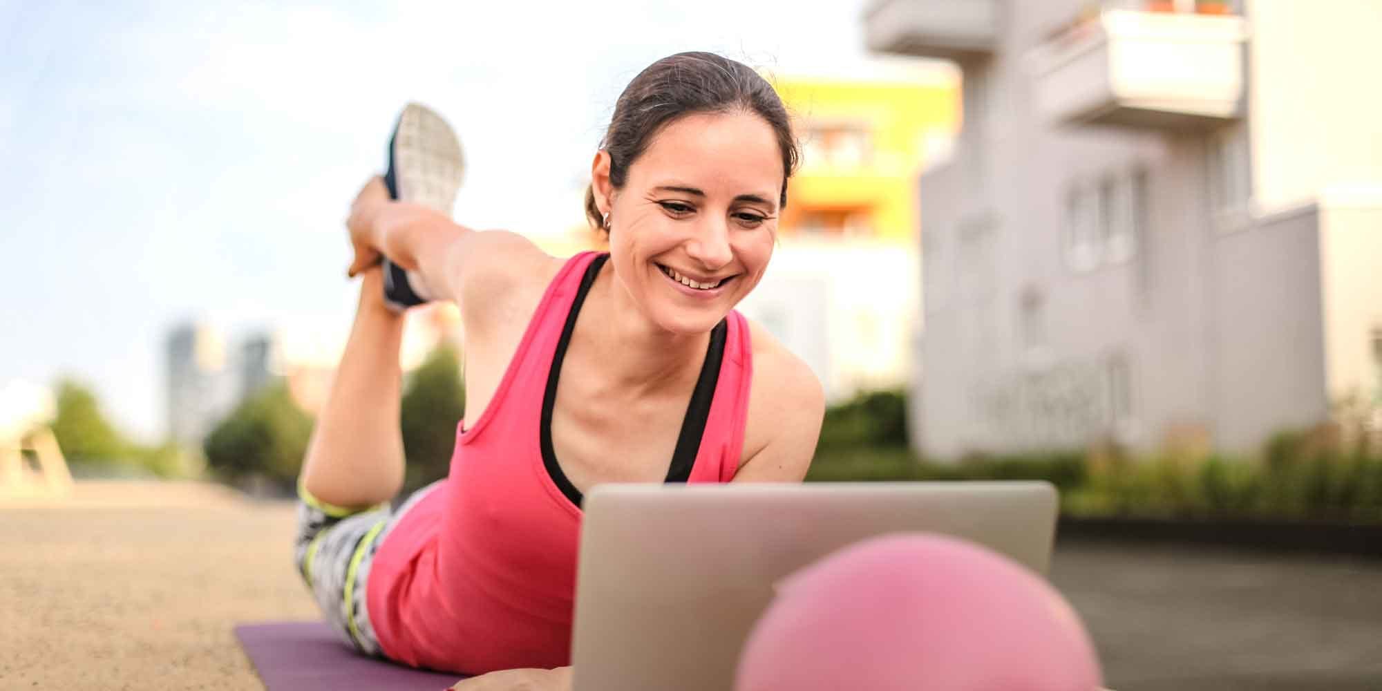 customer engagement illustrated by woman exercising to online video